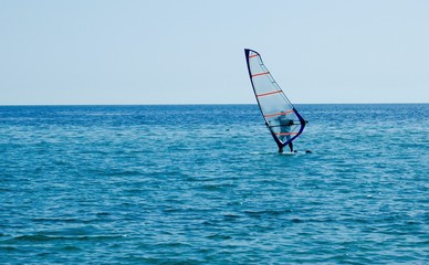 one small sailboat on open sea 