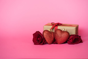 Romantic background with roses and gift box on pink.The concept of St. Valentine's Day, weddings, birthday or International Women's Day. Space for text.