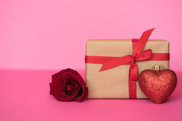 Romantic background with roses and gift box on pink.The concept of St. Valentine's Day, weddings, birthday or International Women's Day.