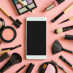 Set of make up brushes and cosmetics with smart phone