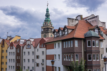 Row of townhouses in Klodzko town, Poland - Town Hall tower on background