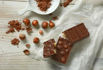chocolate bar with hazelnuts on white table