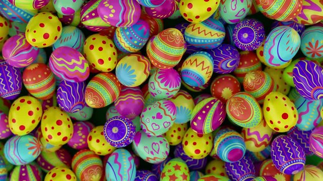 Colorful Easter eggs, fall into the frame and fill it completely. Green background.