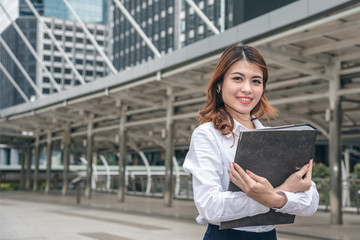 Fototapeta premium Portraits of beautiful asian woman look cheerful and confidence is standing in outdoors while feeling success with work.