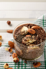 chia pudding with chocolate banana smoothie in a glass jar on the old wooden background