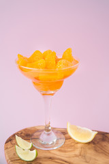 A wineglass of peeled tangerines