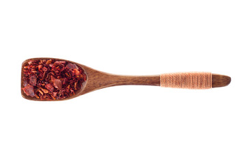 spice chili pepper flakes  in  wooden spoon isolated on a white background, top view
