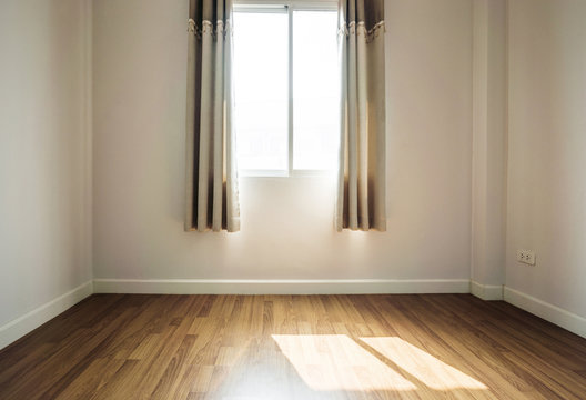 Interior Space, Empty Room, Laminate Wooden Floor With Opened Window Receiving Sunlight In The Morning