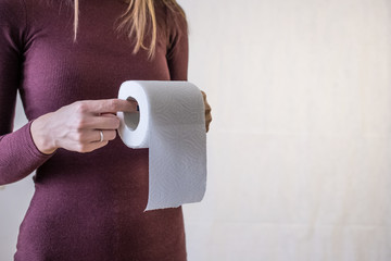 woman take toilet paper. Burgundy dress and white background
