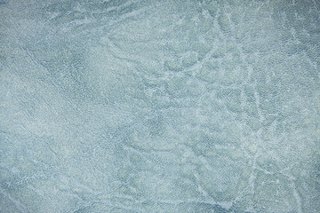 The colored heterogeneous leather texture. The fabric in light, dark blue and white tints. Artistic retouching. Perfect background for the different kinds of illustrations and collages.