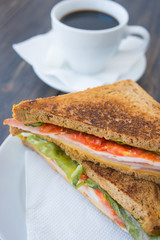 Toasted sandwiches with ham and a cup of black espresso