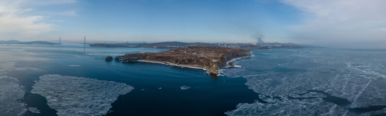 Lighthouse at Cape Basargin, Golden Horn Bay, Vladivostok symbol. Russky island. Landscape...