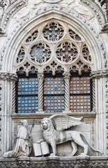 Venetian lion and Doge on a cathedral building on San Marco square in Venice, Italy. Venice's symbol the winged lion