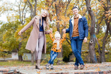 Happy family walks through the Park Winter forest