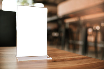 Mock up Menu frame standing on wood table in Bar restaurant cafe. space for text
