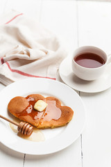 heart shaped pancakes on a light background. the concept of a festive breakfast for Valentine's Day or a pleasant surprise for a loved one