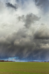 Obraz na płótnie Canvas Dark clouds over land.
