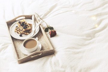 Tray with sweet breakfast and rose