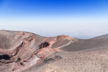 The volcano of Etna, Sicily, Italy. Tourists on the crest of one of the lateral craters