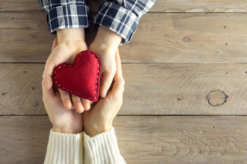 Red heart in hands