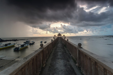 Fototapeta premium Long exposure Cloudy sunrise shot at jetty. Image contain certain grain or noise and soft focus when view at full resolution