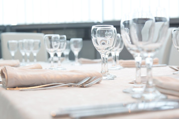 Served table in the restaurant with glasses, napkins and cutlery