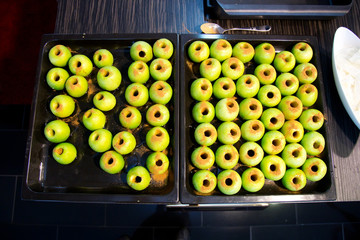 Fresh green apples with cinnamon in a pot for baking