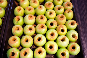 Fresh green apples with cinnamon in a pot for baking