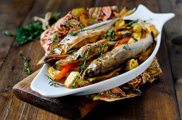 Fish (smelt) baked with potatoes and carrots