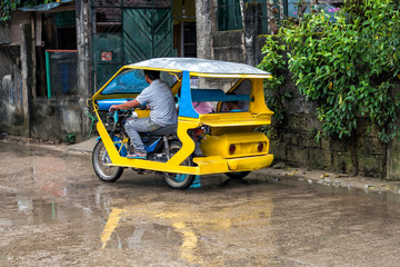 Fototapeta premium Tricycles on El Nido city centre after the rain, Philippines