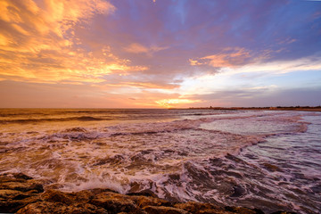 Obraz premium Coucher de soleil à la mer. Ciel nuageux, coloré. Mer agitée.