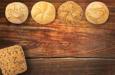 Delicious fresh bread on old wood table, bun
