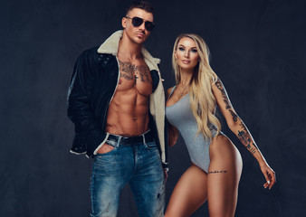 Fototapeta na wymiar Sexy young fitness pair posing together