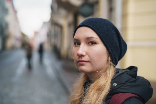 portrait of teen girl walking in Old Tallinn in autumn