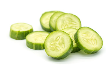 Closeup Slices of green cucumber isolated on white background .
