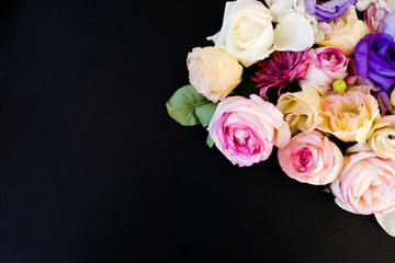 beautiful flowers assortment on dark background. free space concept. floristic art