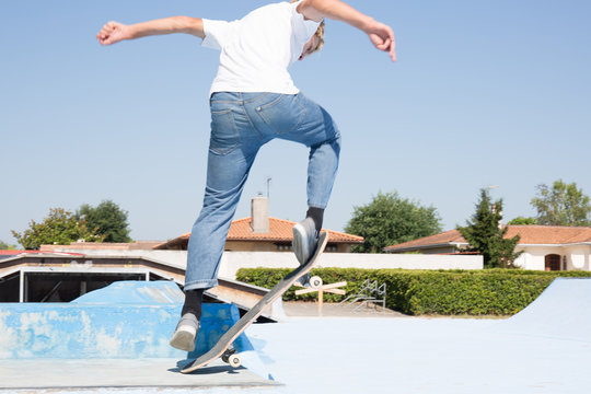 Boy Skateboarding Jump Lifestyle Hipster Concept rear view