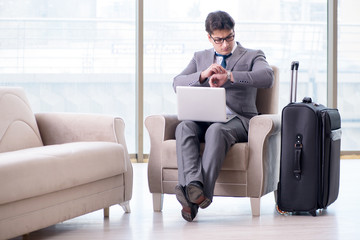 Young businessman in airport business lounge waiting for flight