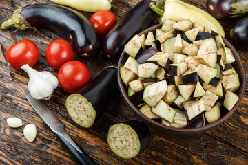 raw diced eggplant in a bowl, tomato and garlic, detail of a cut