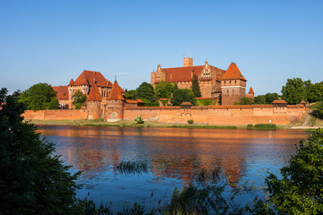 Fototapeta na wymiar Malbork Castle across Nogat river in Poland