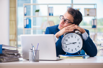 Businessman with giant clock failing to meet deadlines and missi