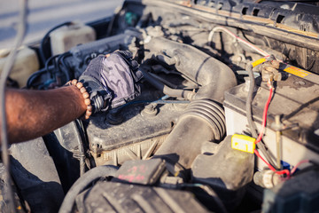 hand with gloves of mechanician checking the engine machine