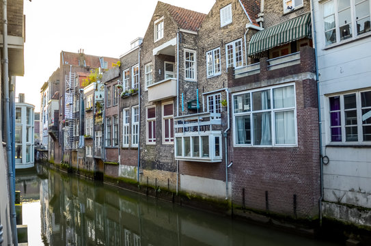 DORDRECHT, NETHERLANDS - OCTOBER, 17 2014: Facade of elegant brick buildings and street old town with houses at the canals Dordrecht Holland. South Netherlands.