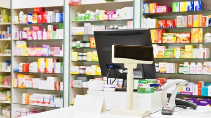 Cash desk - computer and monitor in a pharmacy. Interior of drug and vitamins shop. Medicines and vitamins for health and healthy lifestyle