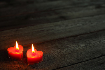 Obraz na płótnie Canvas Heart shaped candles burning