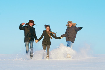 Fototapeta na wymiar happy young people running winter outdoors