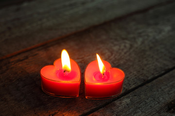 Heart shaped candles burning