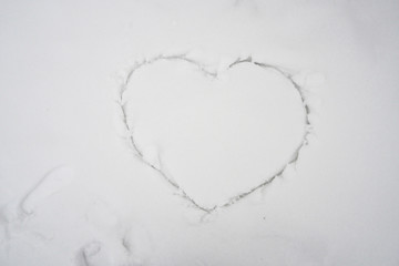 Close up white snow with heart shape.