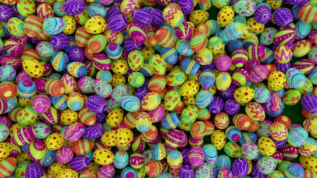 Colorful Easter eggs, fall into the frame and fill it completely. Green background.