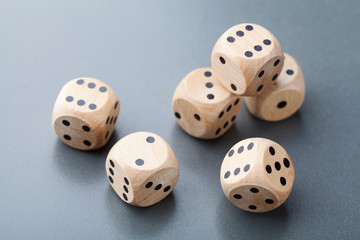 Wooden dice on gray table. Board game. Gambling devices.